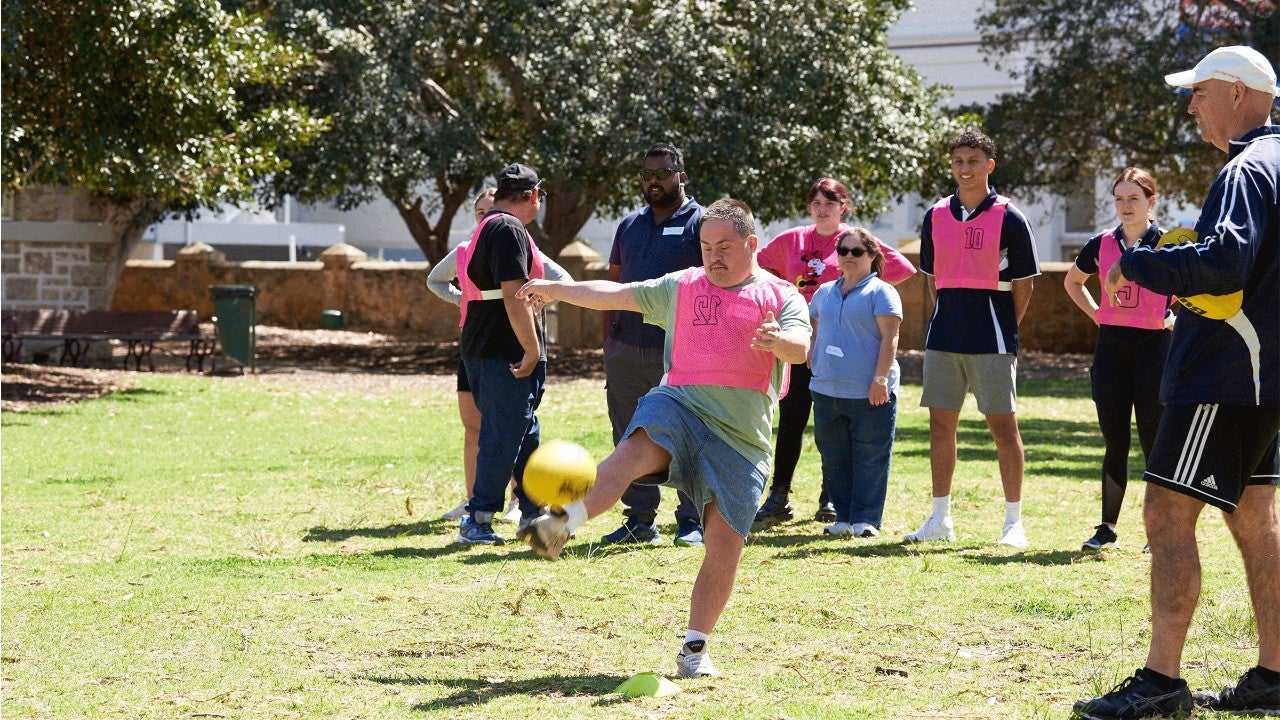 man kicking footy reclink