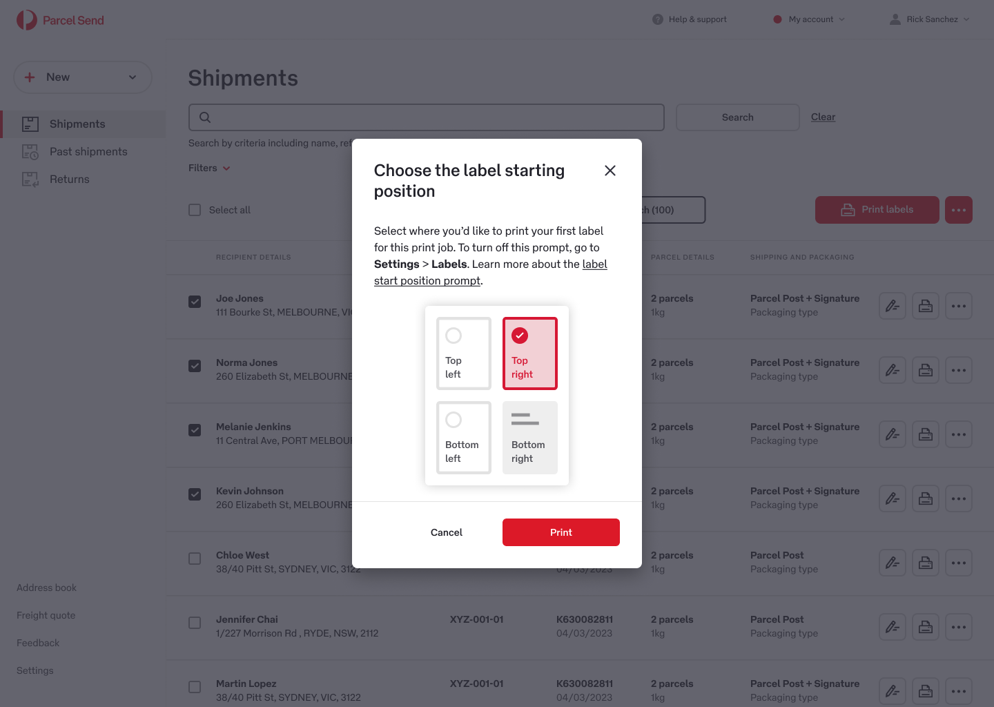 A digital interface displays a pop-up for choosing the label starting position on a shipment page. The options include top left, top right, bottom left, and bottom right, with 'Top right' selected. The background shows a list of shipments with sender and recipient details, and a red 'Print' button is visible. The interface uses a clean, modern design with a light color palette.