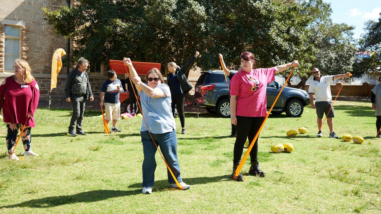 women using strength bands in park reclink